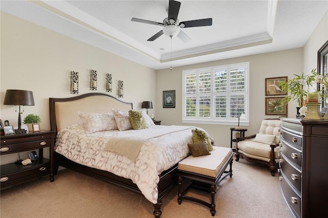 bedroom featuring light colored carpet, a raised ceiling, ceiling fan, and crown molding