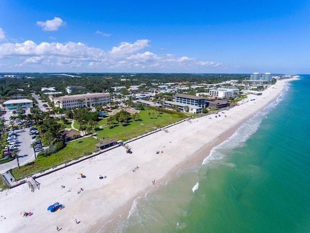 birds eye view of property with a beach view and a water view