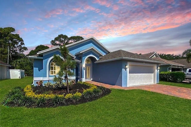 view of front of home featuring a garage and a lawn