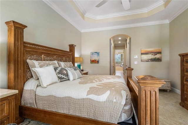 bedroom with ceiling fan, ornamental molding, and a tray ceiling