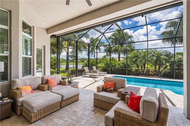 view of pool featuring ceiling fan, outdoor lounge area, glass enclosure, and a patio area