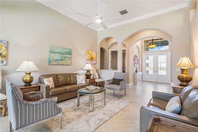 living room with ornamental molding, light tile patterned flooring, ceiling fan, and french doors