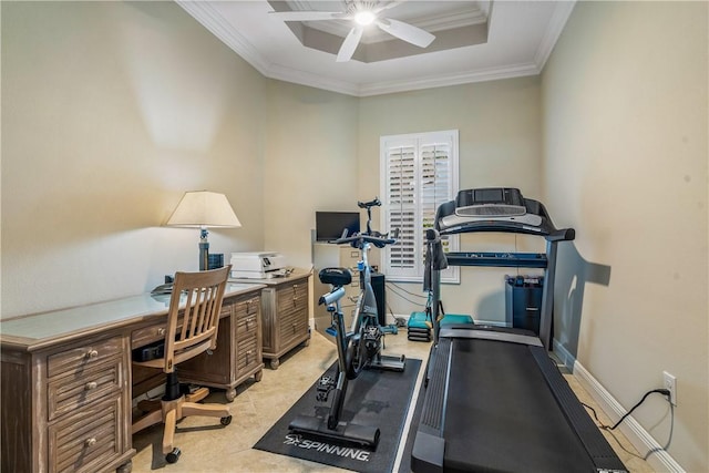 workout room featuring ornamental molding, ceiling fan, and a tray ceiling