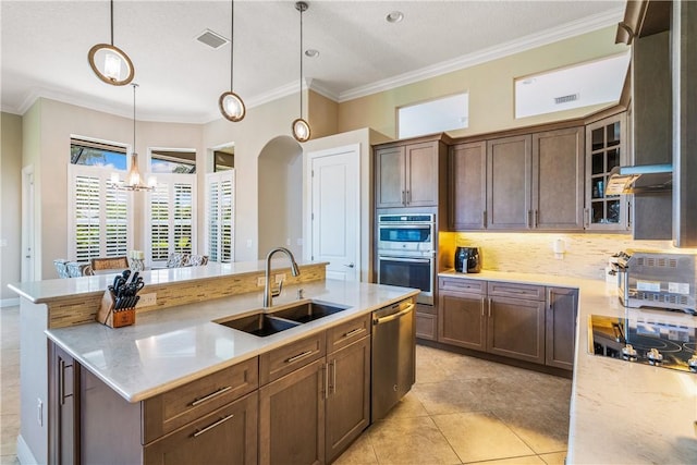 kitchen featuring light tile patterned flooring, sink, ornamental molding, pendant lighting, and stainless steel appliances