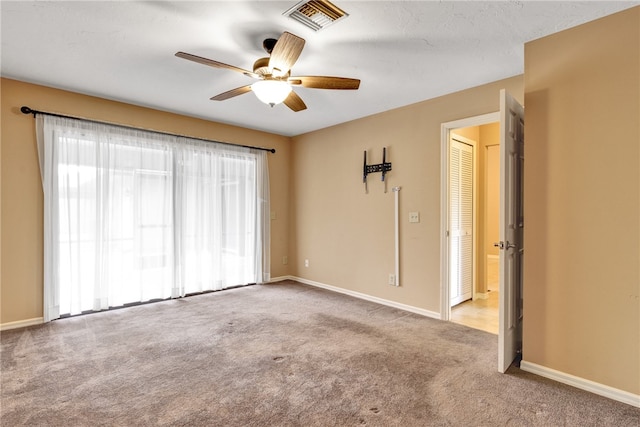 unfurnished room featuring light colored carpet and ceiling fan