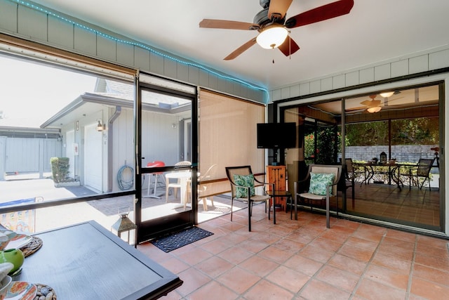 sunroom featuring ceiling fan and a healthy amount of sunlight