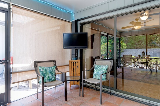 sunroom / solarium featuring ceiling fan