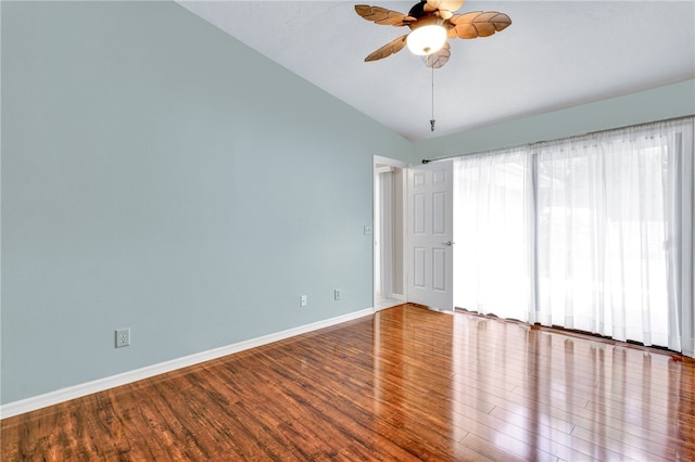 empty room with hardwood / wood-style floors, vaulted ceiling, and ceiling fan