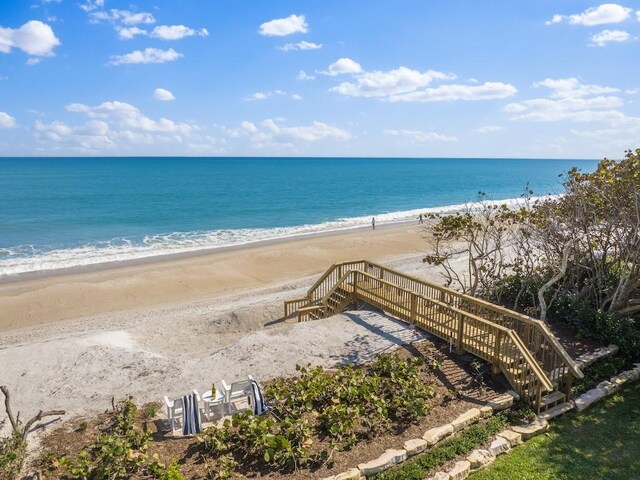 view of home's community with a view of the beach and a deck with water view