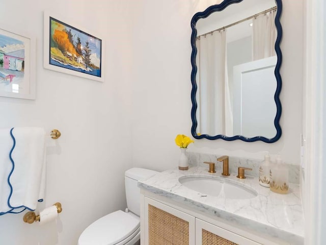 bathroom with vanity and toilet