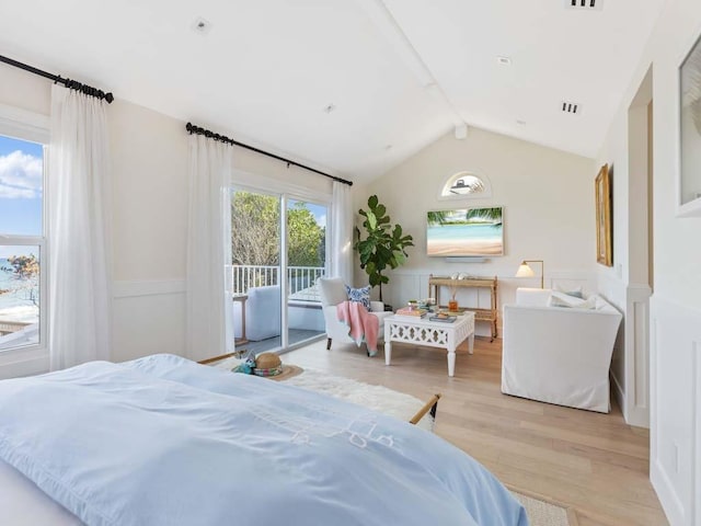 bedroom with lofted ceiling with beams, light hardwood / wood-style floors, and access to outside