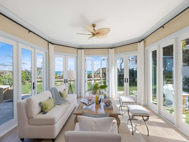 sunroom featuring french doors and ceiling fan