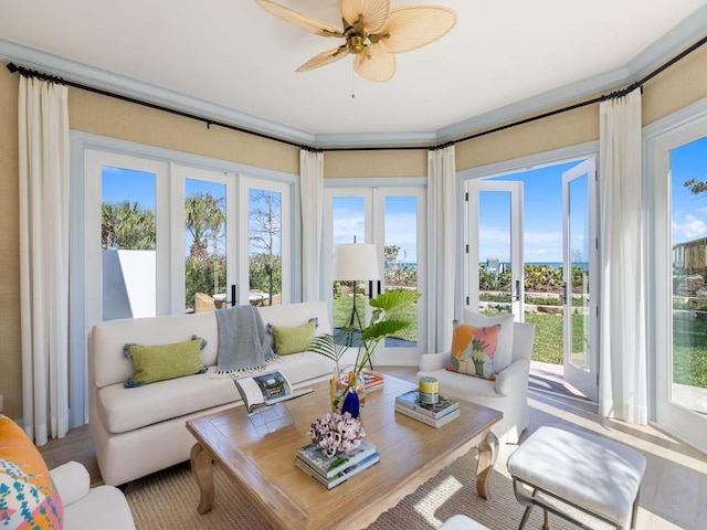 sunroom / solarium featuring french doors and ceiling fan