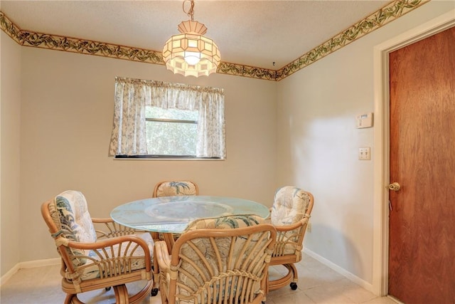 dining area featuring a textured ceiling