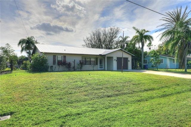 ranch-style home with a garage and a front lawn