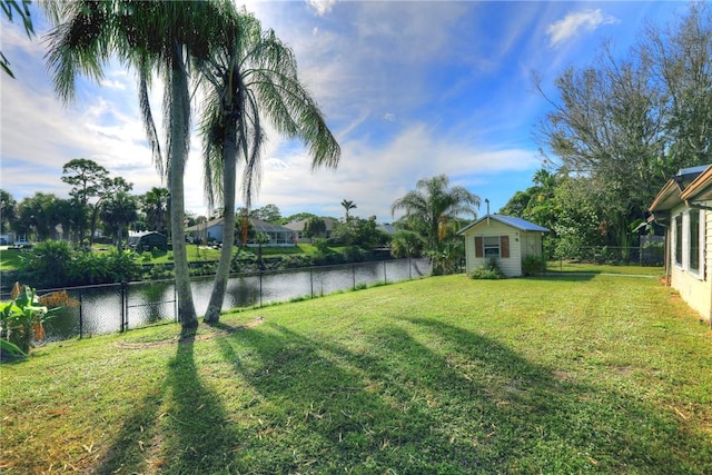 view of yard featuring a water view and an outdoor structure