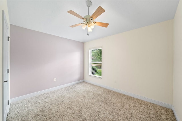 carpeted spare room featuring ceiling fan