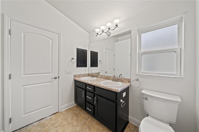 bathroom featuring lofted ceiling, toilet, tile patterned flooring, a textured ceiling, and vanity