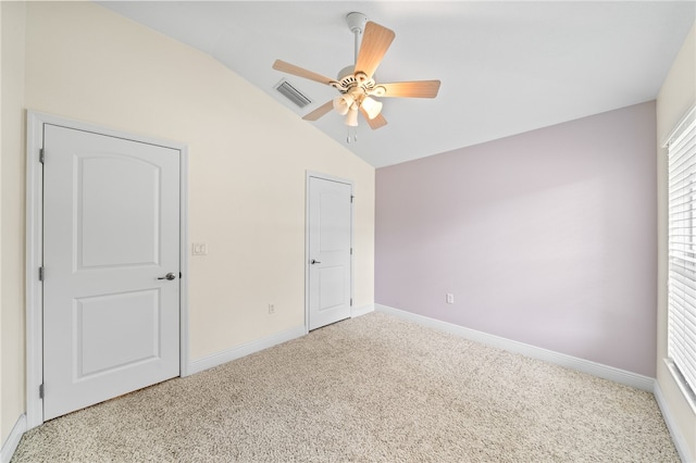 unfurnished bedroom with lofted ceiling, carpet, and ceiling fan