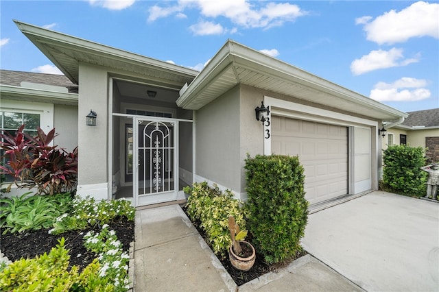 doorway to property with a garage