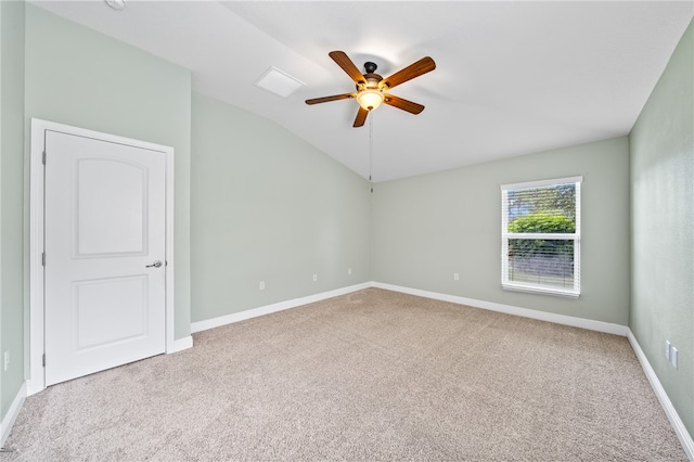 carpeted empty room with ceiling fan and vaulted ceiling