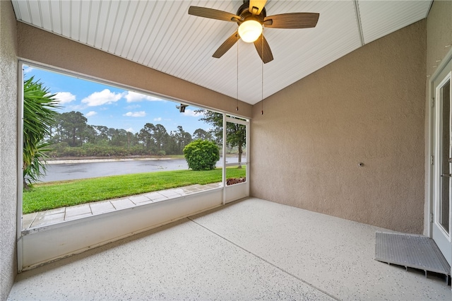 unfurnished sunroom with a water view, vaulted ceiling, and ceiling fan