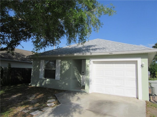 single story home with stucco siding, fence, concrete driveway, an attached garage, and a shingled roof