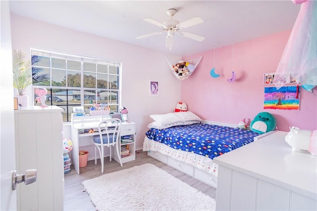 bedroom with light wood-type flooring and ceiling fan