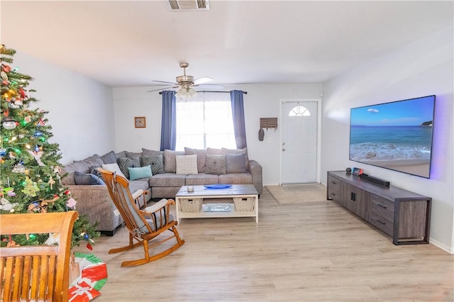 living room with ceiling fan and light wood-type flooring