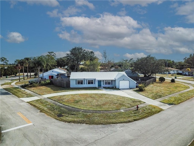 view of front of house with a garage and a front lawn