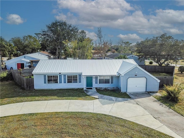 ranch-style home featuring a front lawn and a garage