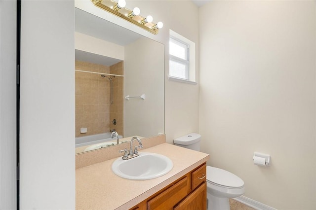 full bathroom with vanity, tiled shower / bath combo, and toilet