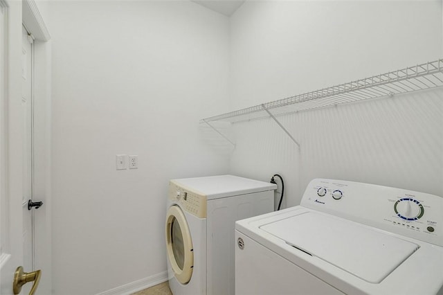 clothes washing area featuring independent washer and dryer