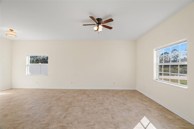 empty room featuring a wealth of natural light and ceiling fan