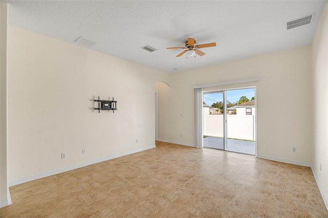 empty room featuring a textured ceiling and ceiling fan