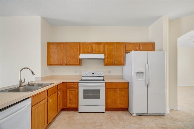 kitchen featuring white appliances and sink