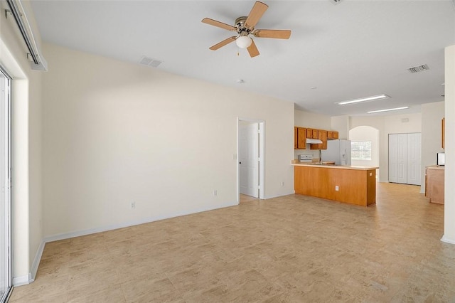 unfurnished living room featuring ceiling fan