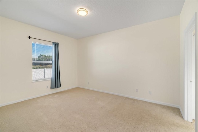 unfurnished room with light carpet and a textured ceiling