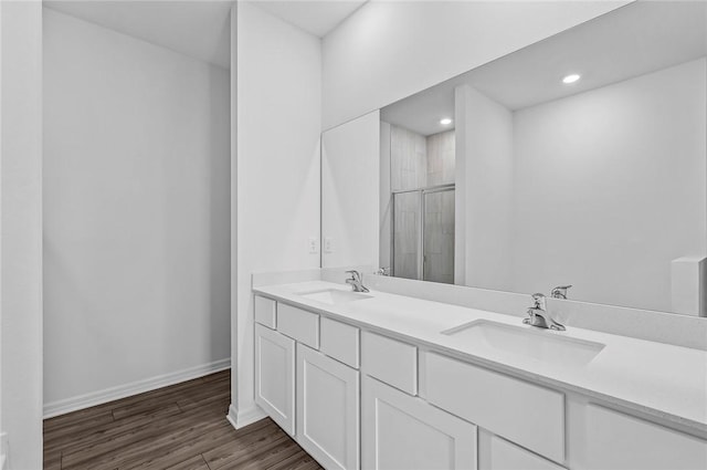 9316 104th Ave, Vero Beach, FL 32967 - full bath with a stall shower, double vanity, wood finished floors, baseboards, and recessed lighting