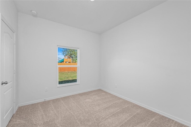 9316 104th Ave, Vero Beach, FL 32967 - spare room featuring carpet flooring, baseboards, and a smoke detector