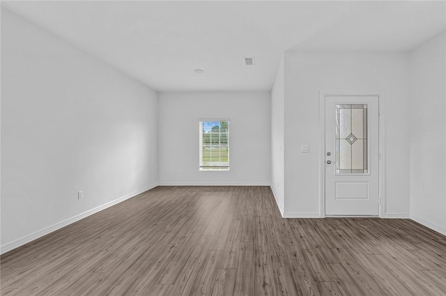 9316 104th Ave, Vero Beach, FL 32967 - empty room featuring wood finished floors and baseboards