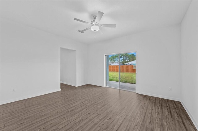 9316 104th Ave, Vero Beach, FL 32967 - spare room featuring ceiling fan, wood finished floors, and baseboards