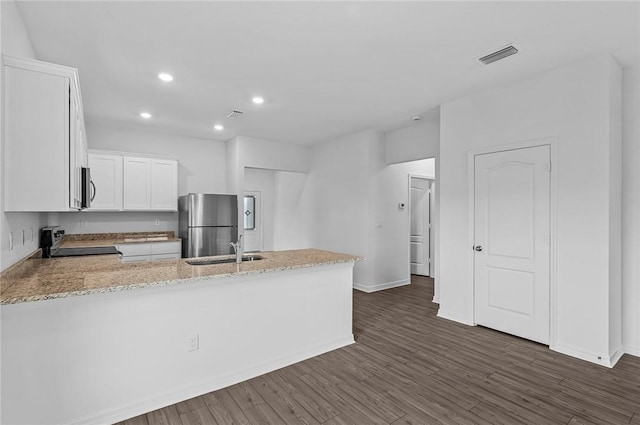9316 104th Ave, Vero Beach, FL 32967 - kitchen featuring stainless steel appliances, a sink, a peninsula, white cabinetry, and light stone countertops