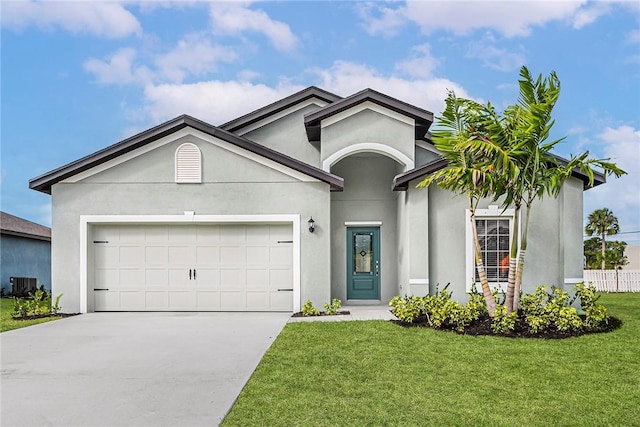 9316 104th Ave, Vero Beach, FL 32967 - ranch-style home with driveway, central air condition unit, a front lawn, an attached garage, and stucco siding