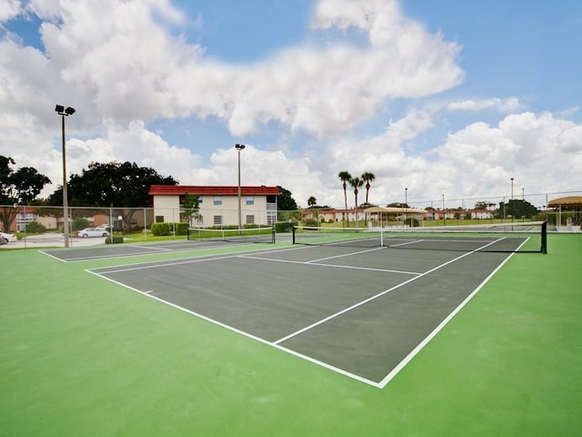 view of tennis court with basketball hoop