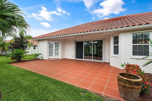 back of house featuring a lawn and a patio area