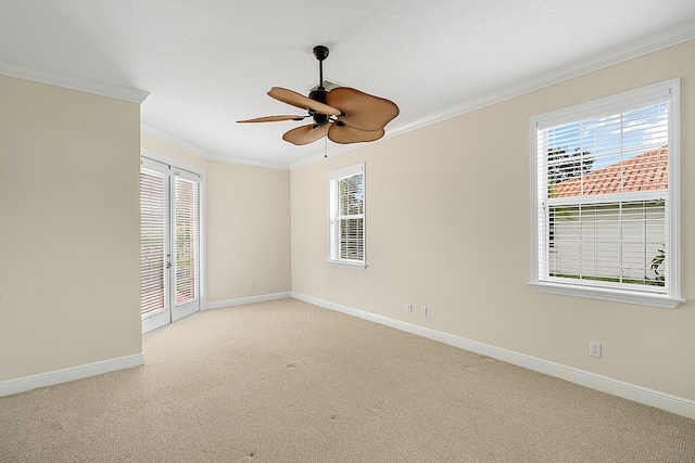 carpeted empty room featuring ornamental molding, a textured ceiling, and ceiling fan