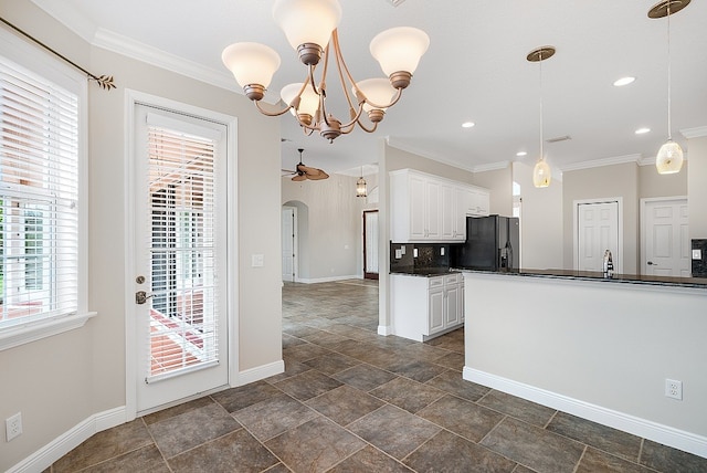 kitchen with ceiling fan with notable chandelier, ornamental molding, white cabinetry, pendant lighting, and black refrigerator with ice dispenser