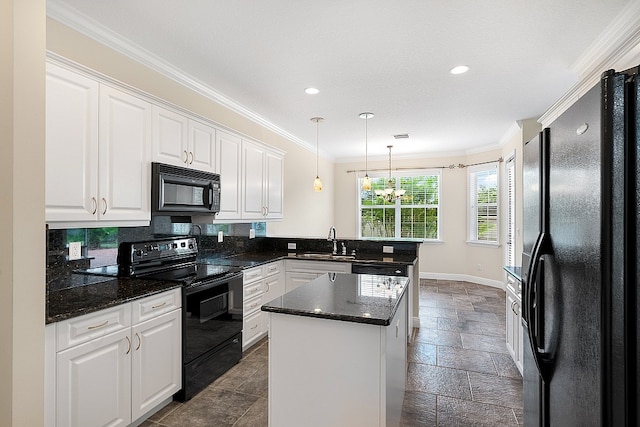 kitchen with a center island, black appliances, sink, pendant lighting, and white cabinetry