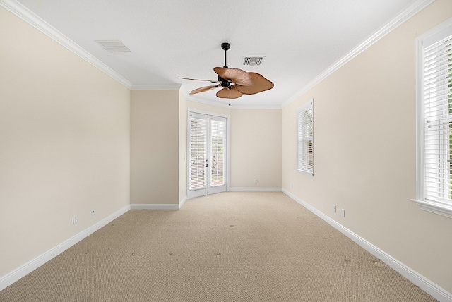 spare room featuring ornamental molding, light colored carpet, and ceiling fan